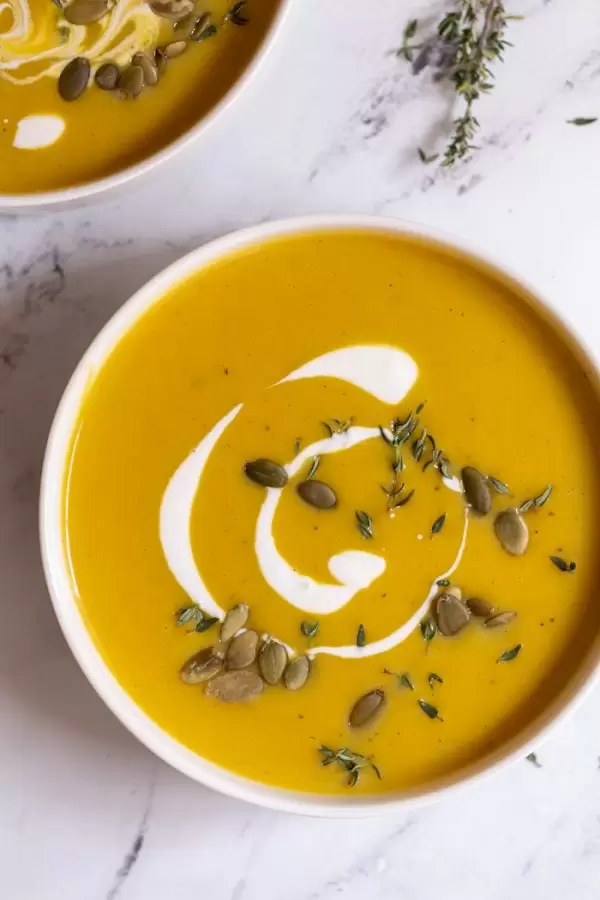 vegan butternut squash soup recipe with cream and pepitas on top