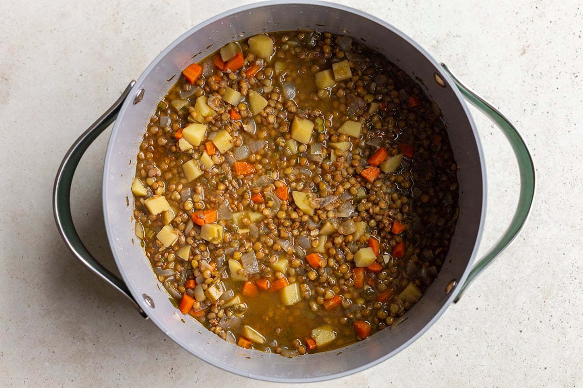 lentil soup in a large pot before it's been blended up