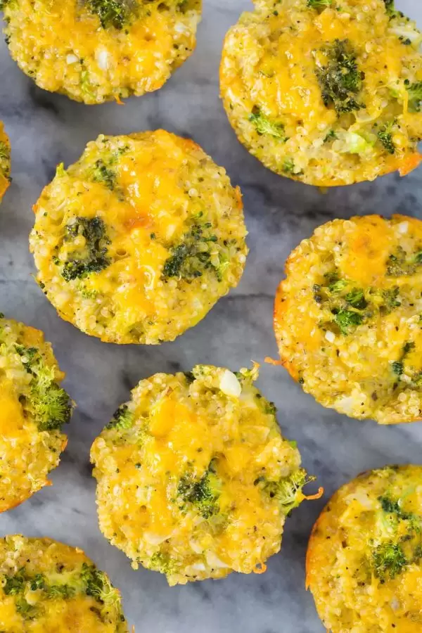 quinoa, cheddar cheese, and broccoli bites on a marble board