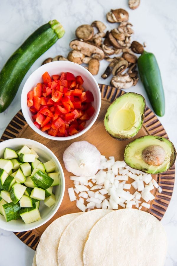 This Loaded Veggie Enchilada Casserole Recipe is a delicious take on traditional enchiladas. An easy dinner that is vegetarian and can even be made into a vegan enchilada casserole if you just leave off the cheese!