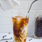 ice coffee with cream being poured in