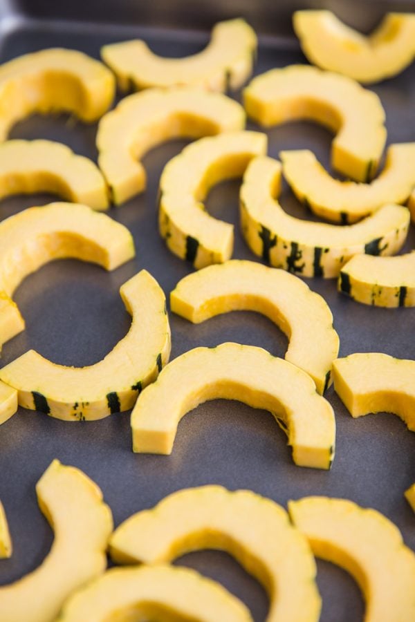 This Roasted Delicata Squash recipe shows you 2 ways to roast delicata squash! A sweet cinnamon recipe and a roasted herb recipe. The perfect side dish!