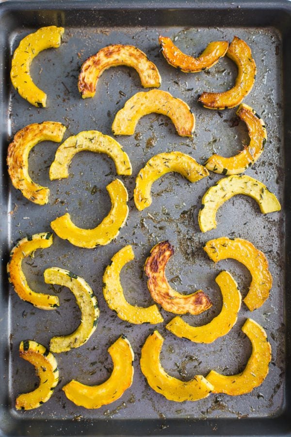 This Roasted Delicata Squash recipe shows you 2 ways to roast delicata squash! A sweet cinnamon recipe and a roasted herb recipe. The perfect side dish!