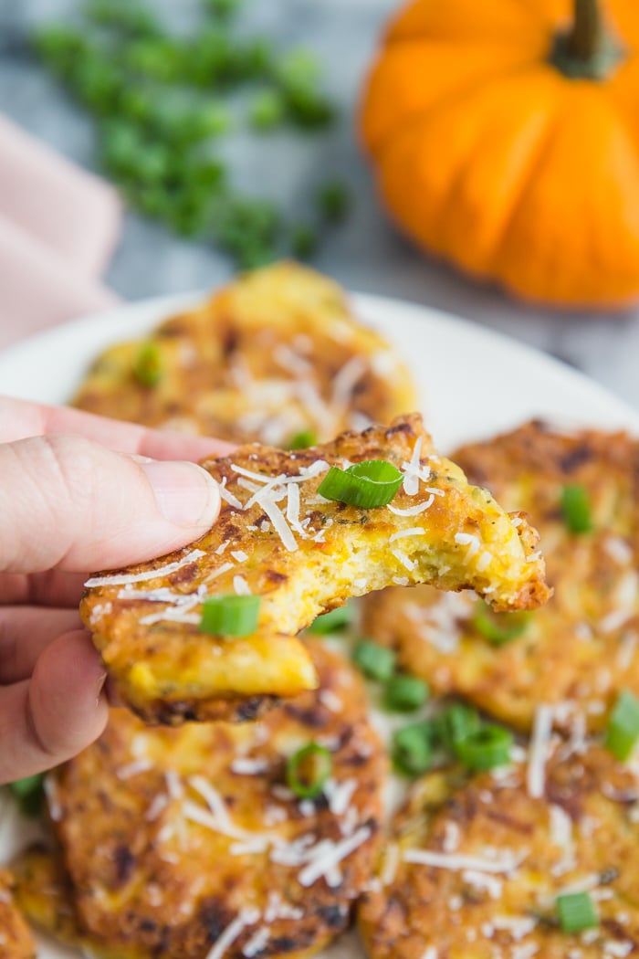 Close-up of freshly fried pumpkin fritters, showing their crispy texture and vibrant orange color, ideal for a savory autumn snack.