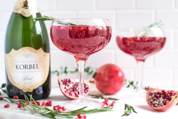 Pomegranate Champagne Cocktail- this holiday cocktail is easy to make in either a single glass or a pitcher to serve a crowd!