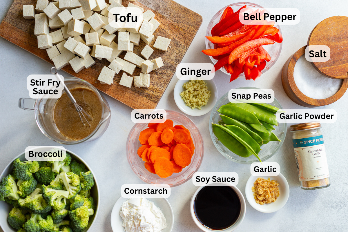 ingredients needed to make tofu stir fry including tofu, stir fry sauce, bell pepper, carrots, broccoli, snap peas