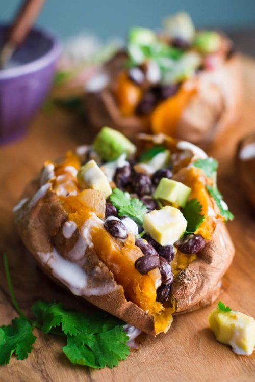sweet potato stuffed with black beans and avocado sprinkled with cilantro