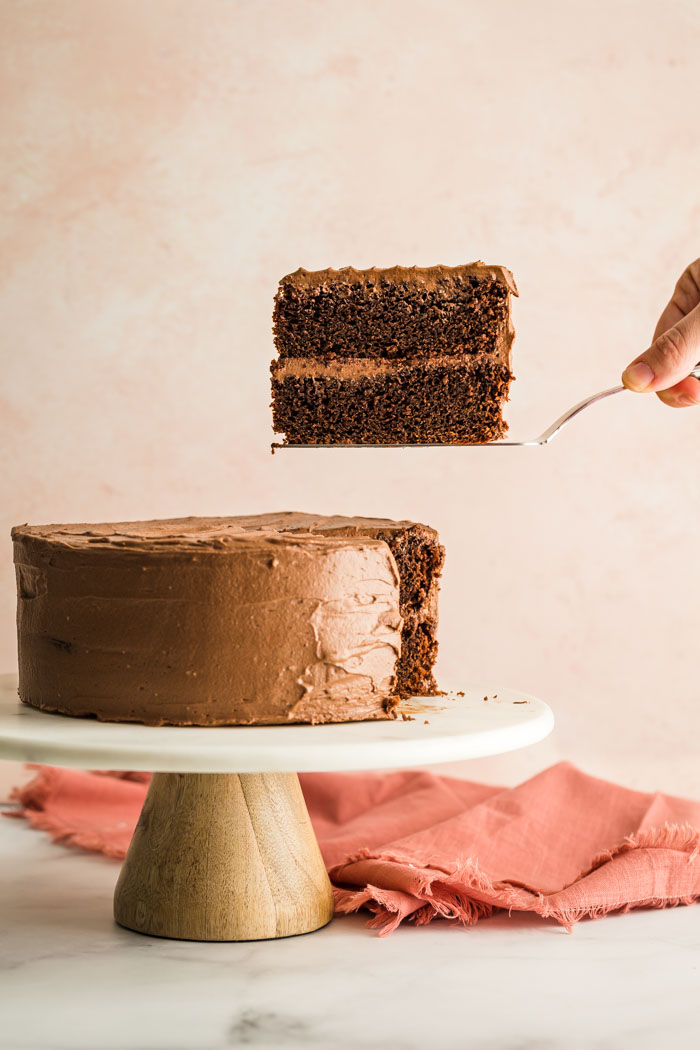 slice of chocolate cake on a marble cake stand