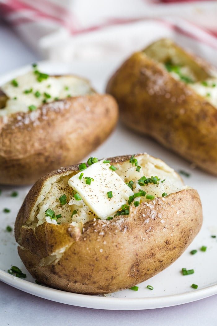 baked potatoes topped with butter and herbs
