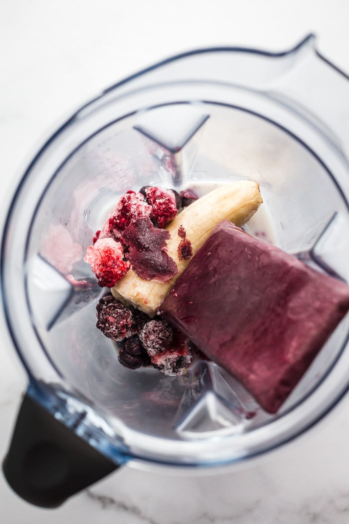 ingredients in a blender to make an acai smoothie bowl