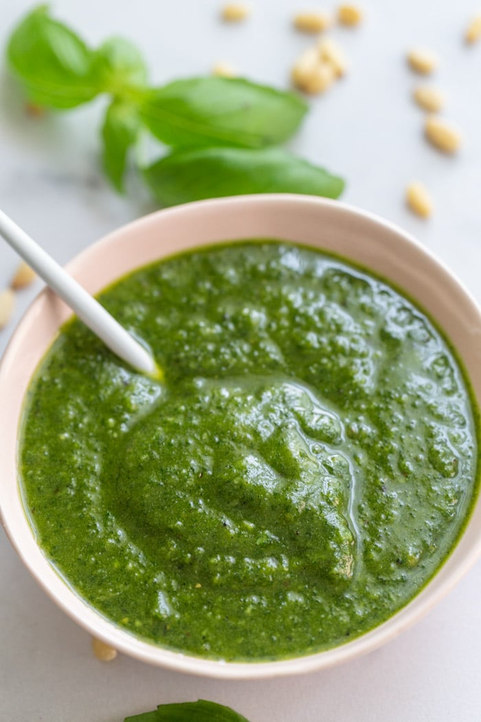 light pink bow lfilled with vibrant vegan pesto
