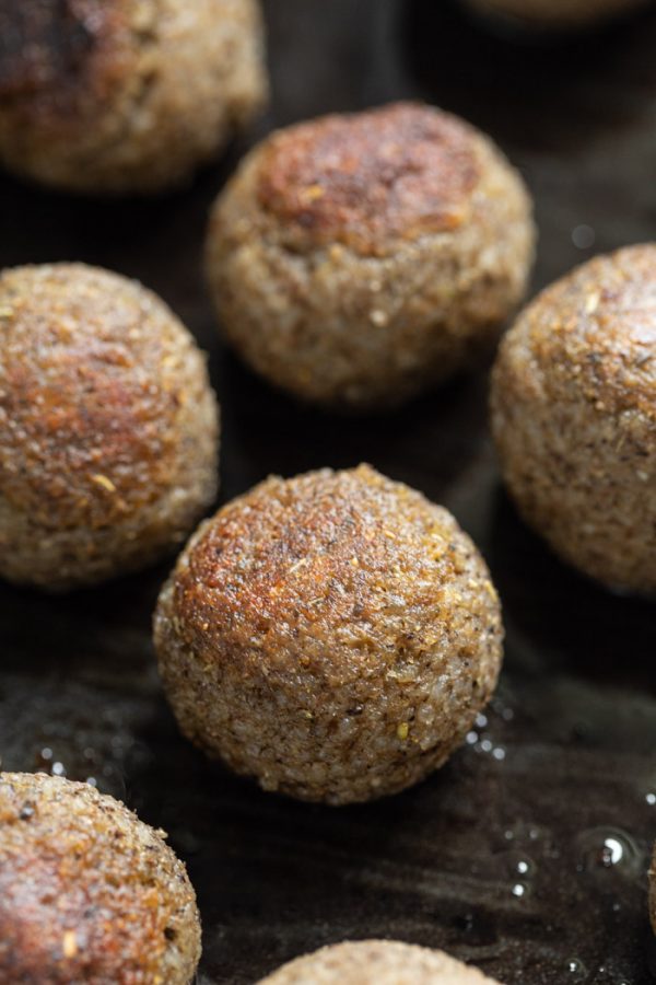 browned vegan meatballs in a black cast iron skillet. how to make vegan meatballs