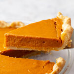 slice of sweet potato pie being lifted from the pan