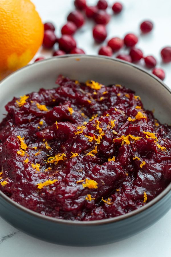 homemade cranberry sauce topped with orange zest in a bowl