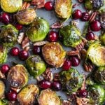 sheet pan filled with roasted brussels sprouts, fresh cranberries and roasted pecans