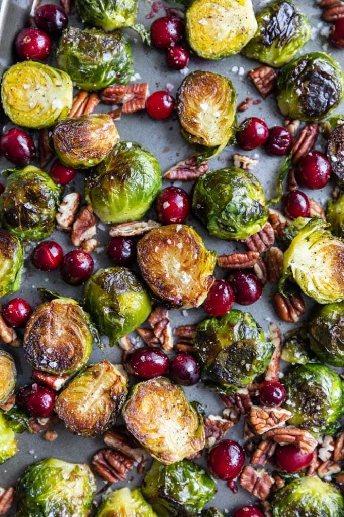 sheet pan filled with roasted brussels sprouts, fresh cranberries and roasted pecans