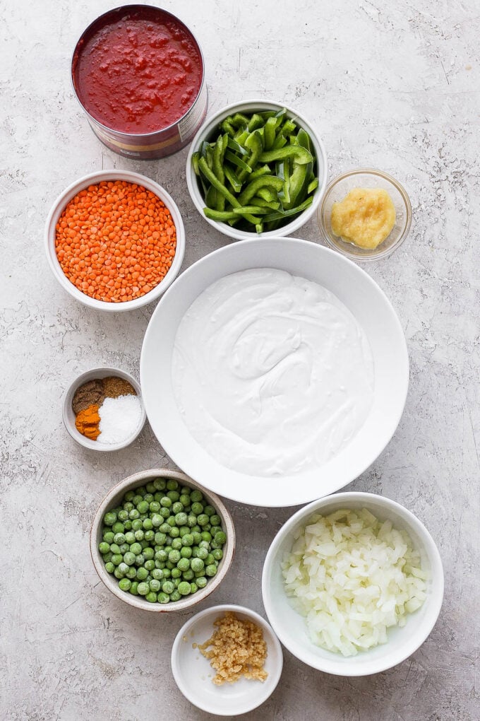 Ingredients to make curry with lentils divided into small bowls.