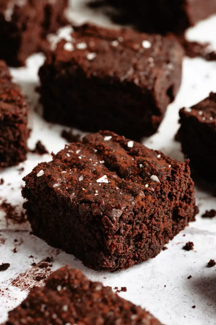 vegan brownies with sea salt on a white background