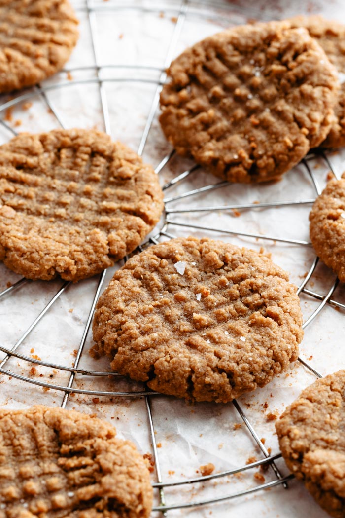 vegan peanut butter cookies on a white background and a cooling rack