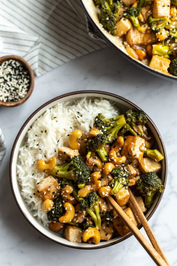 cashew tofu stir fry over white rice in a bowl