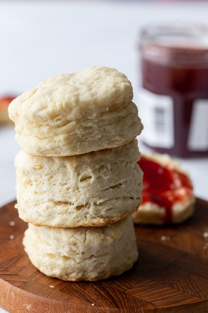 stack of 3 vegan biscuits on a wood board