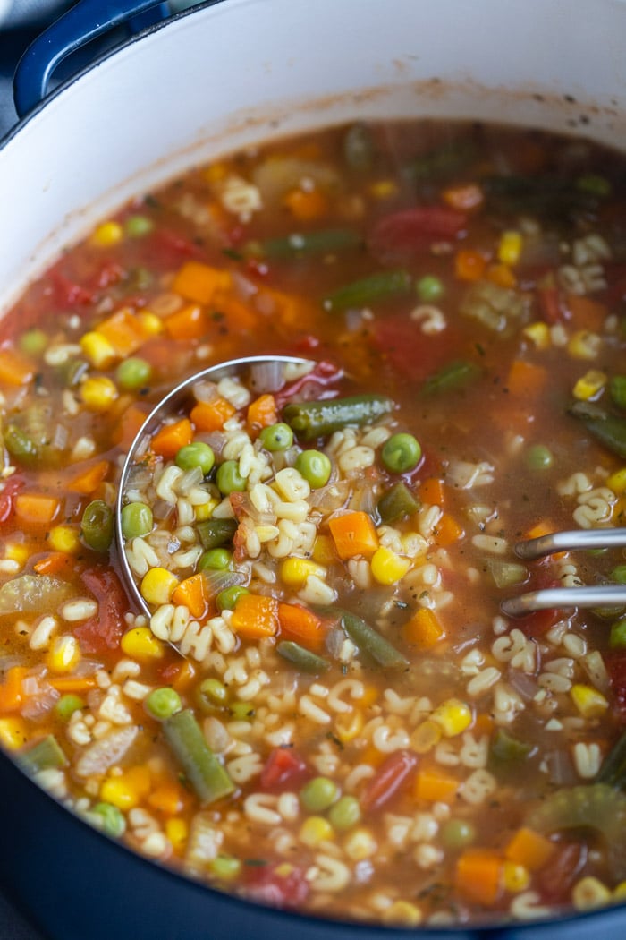 up close shot of vegetable alphabet soup in a pot