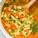 Chickpea noodle soup cooking in a large pot.