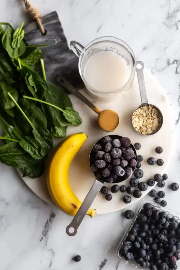 ingredients displayed on a marble board for making a smoothie