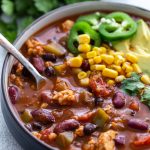 tempeh chili topped with sliced jalapeños