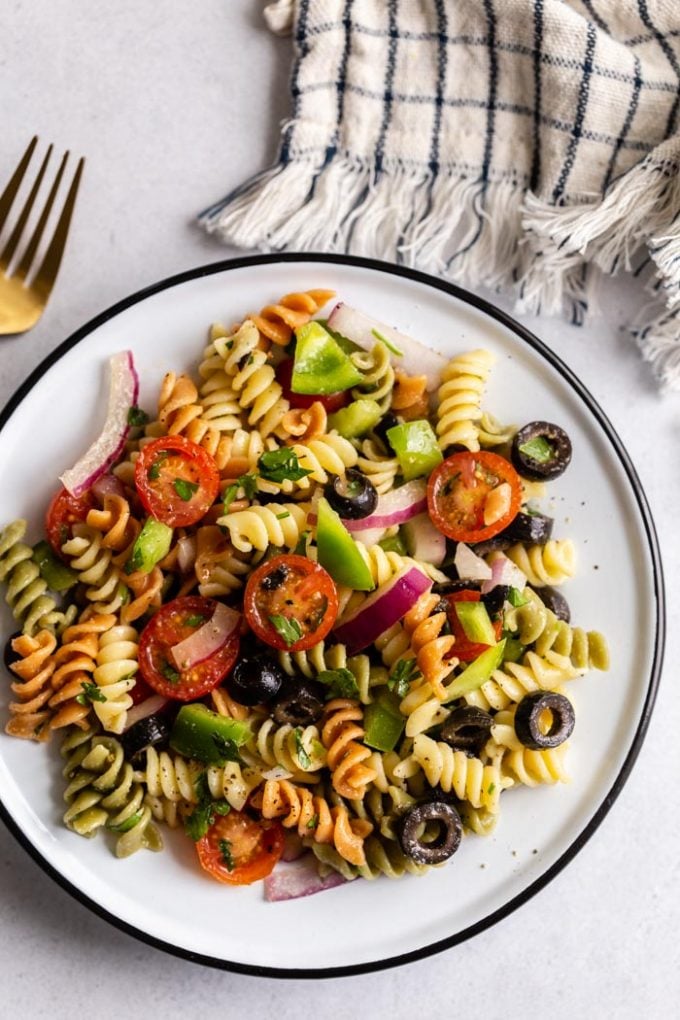 shot of pasta salad with tri color past spirals and veggies