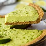 piece of key lime pie being pulled away from the rest of the pie