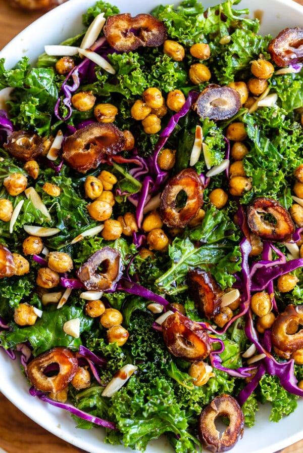 date kale salad in a large bowl with chickpeas and red cabbage