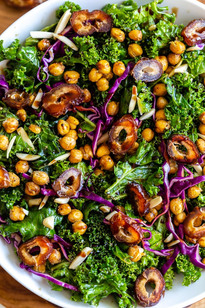 date kale salad in a large bowl with chickpeas and red cabbage