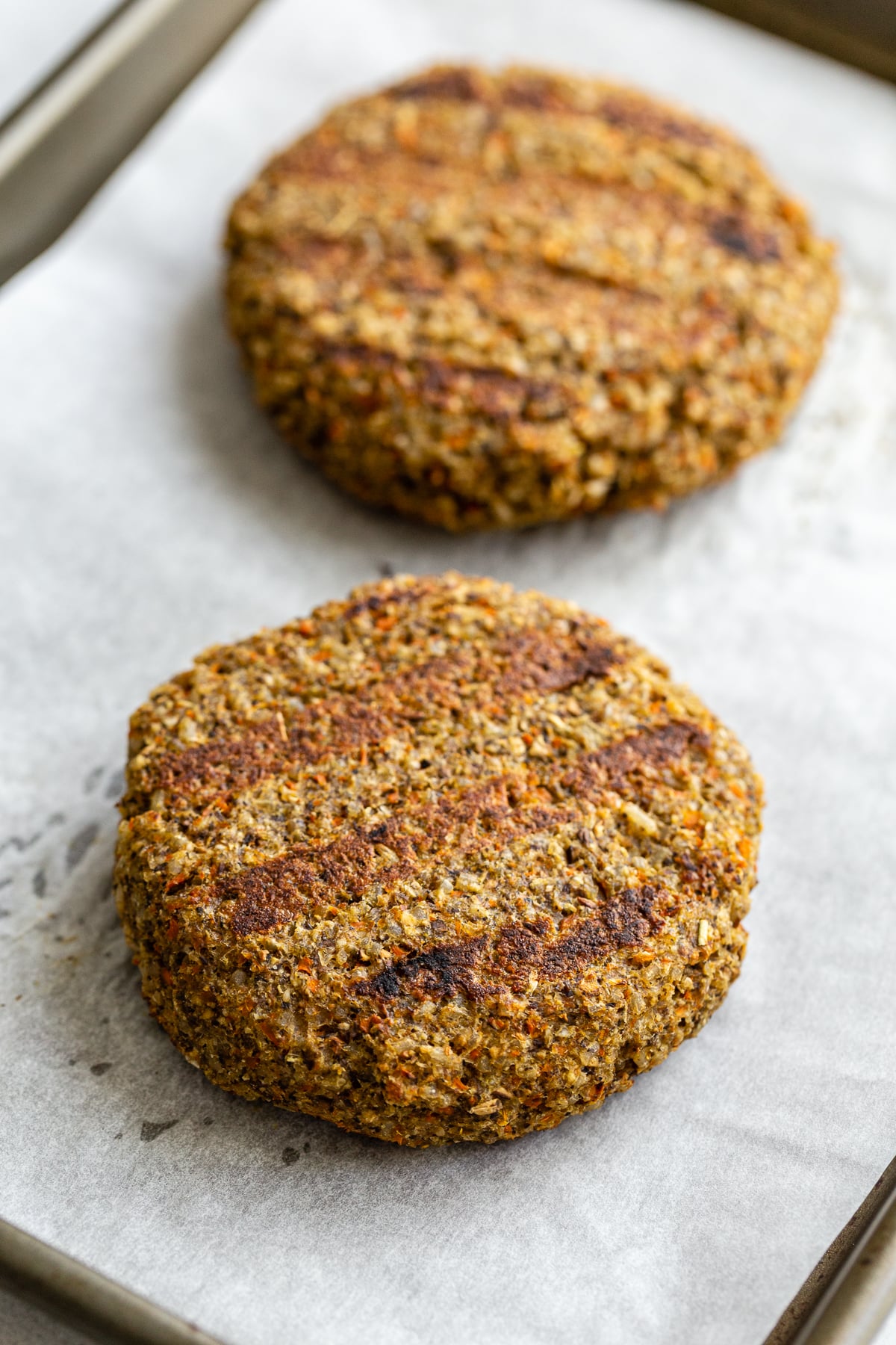 grilled veggie burger patties on a plate where you can see the grill marks