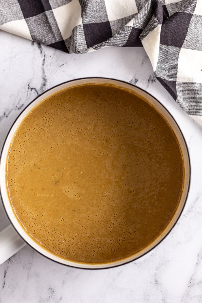 white pot filled with brown vegan gravy