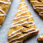 vegan apple turnovers covered with a drizzle of icing