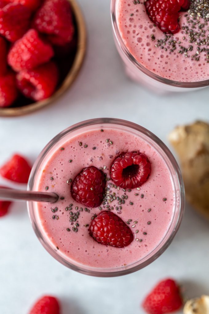 pink raspberry smoothie with fresh raspberries and chia seeds on top