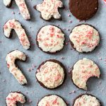 sheet pan filled with chocolate cut out cookies and tppped with a vanilla frosting and crushed peppermint