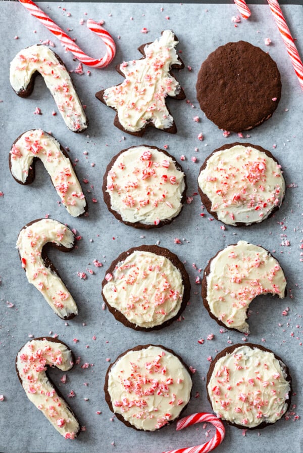 sheet pan filled with chocolate cut out cookies and tppped with a vanilla frosting and crushed peppermint