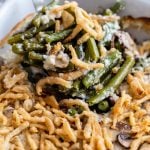 up close shot of green bean casserole in a baking dish and covered with crispy onions