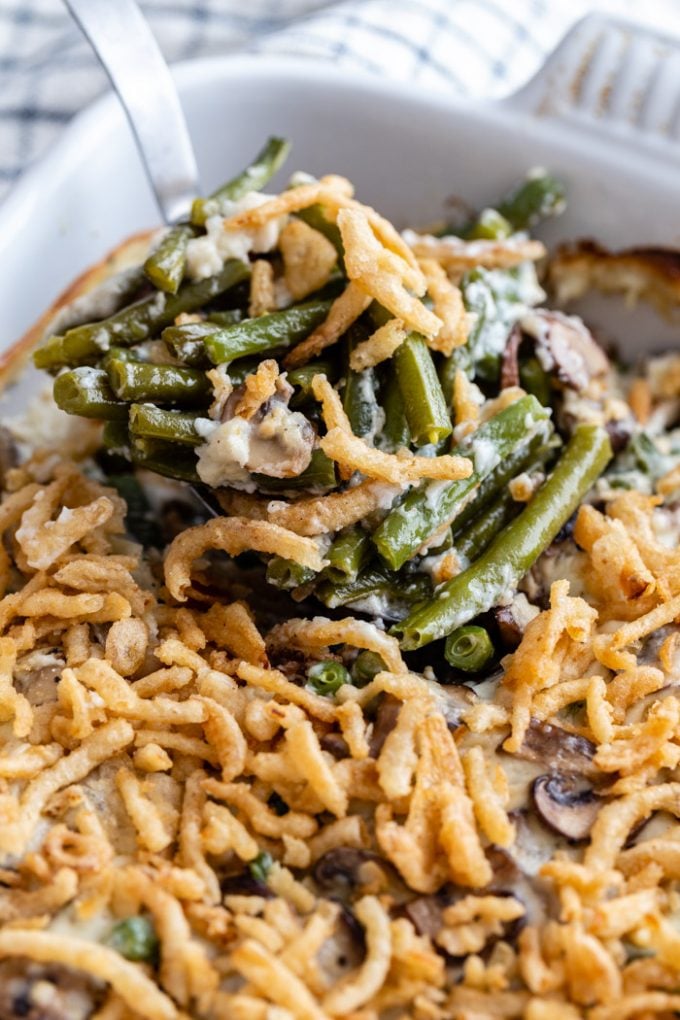 up close shot of green bean casserole in a baking dish and covered with crispy onions