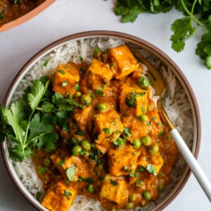 tofu tikka masala served over rice and garnished with cilantro