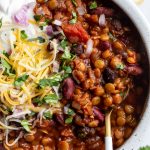 lentil chili topped with cheese, sour cream and fresh cilantro