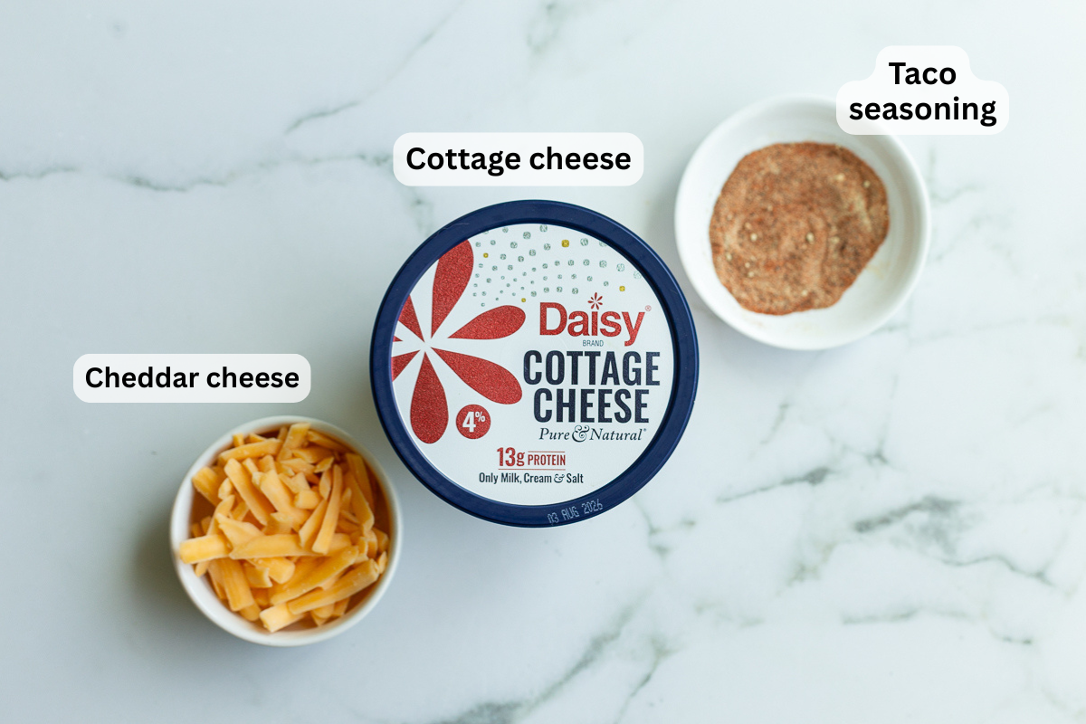 ingredients needed to make cottage cheese queso including cottage cheese, shredded cheese and taco seasoning