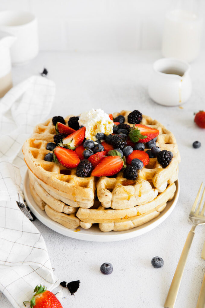 easy vegan waffles served with berries and whipped cream