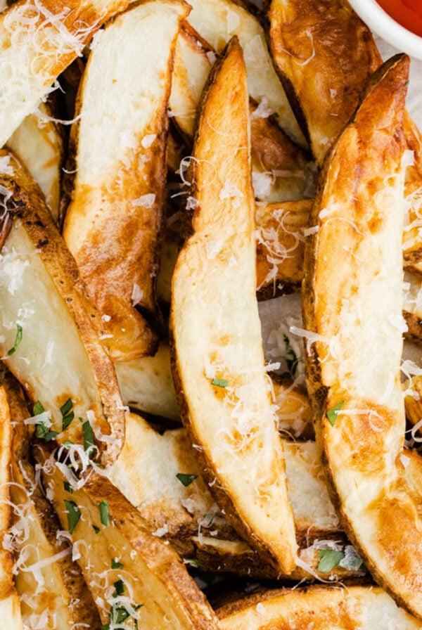air fryer potato wedges topped with parsley and parmesan