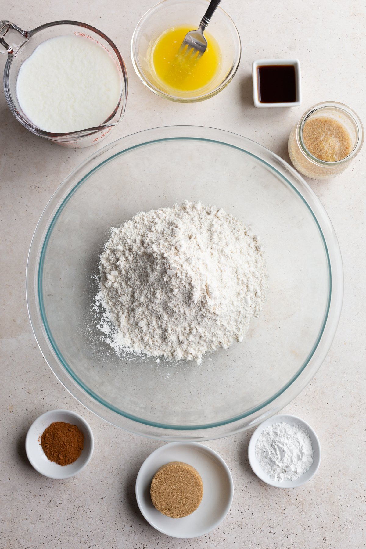 Bowls with flour, milk, sugar, and cinnamon.