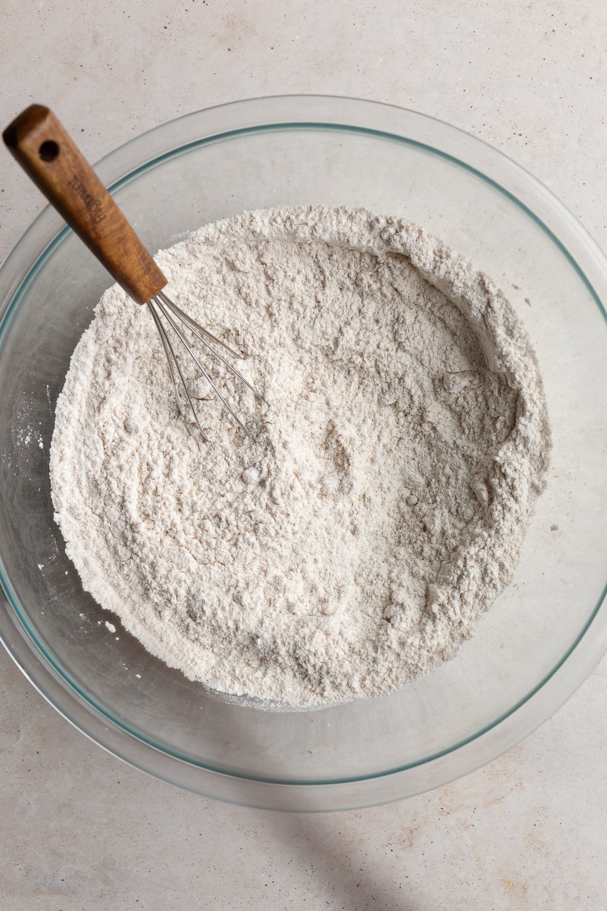 Whisking together flour with baking powder and brown sugar.