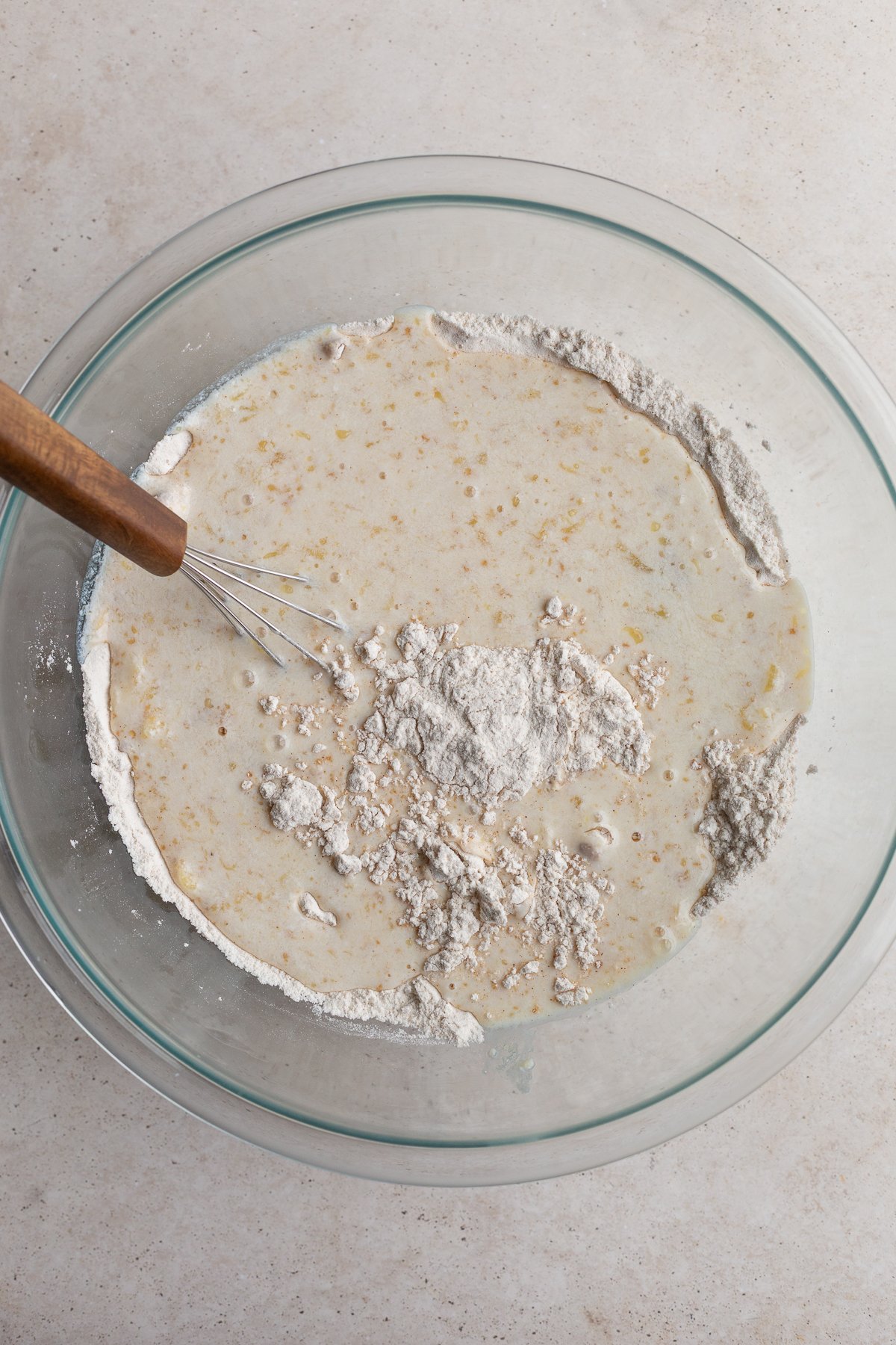 Mixing together the waffle batter in a large bowl.