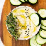 Baba Ganoush with a slice of cucumber dipped in